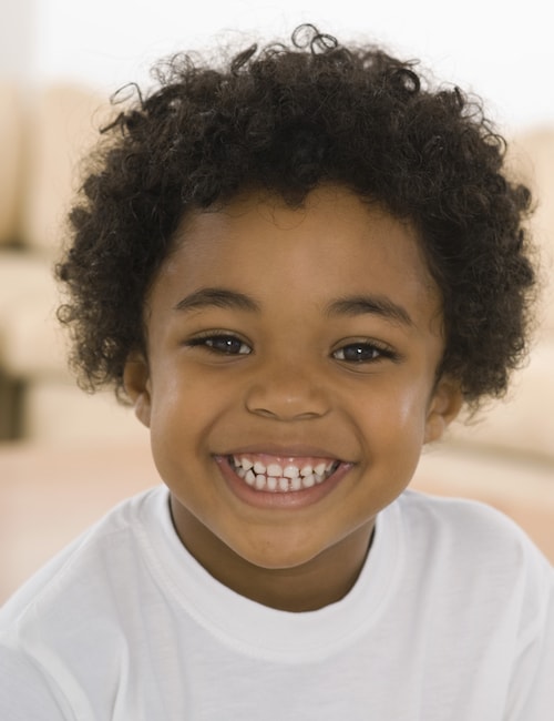 Little boy smiling and showing his teeth because he feels relaxed