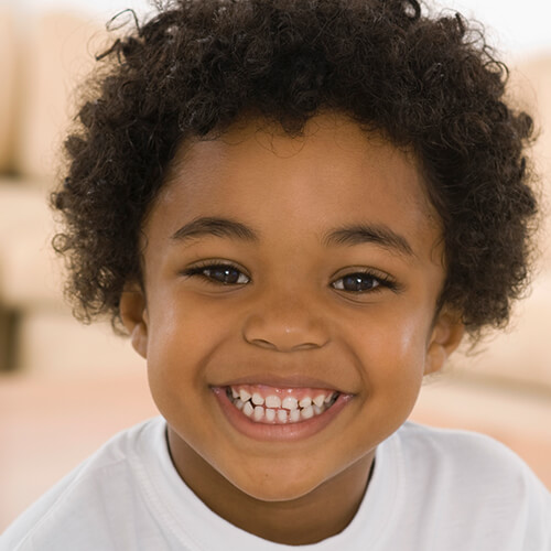 A little boy smiling to camera